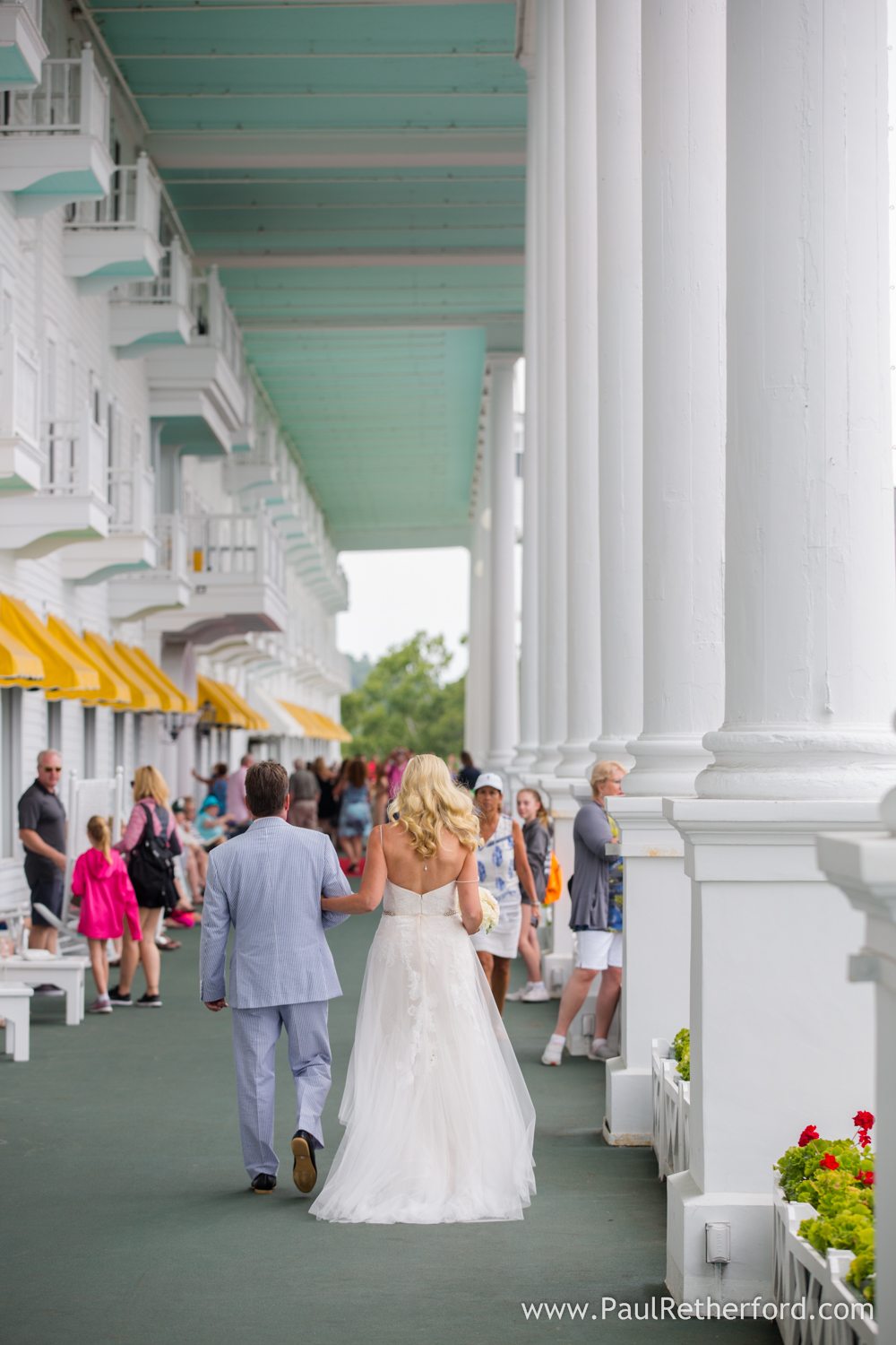 bride walking on grand hotel porch photo