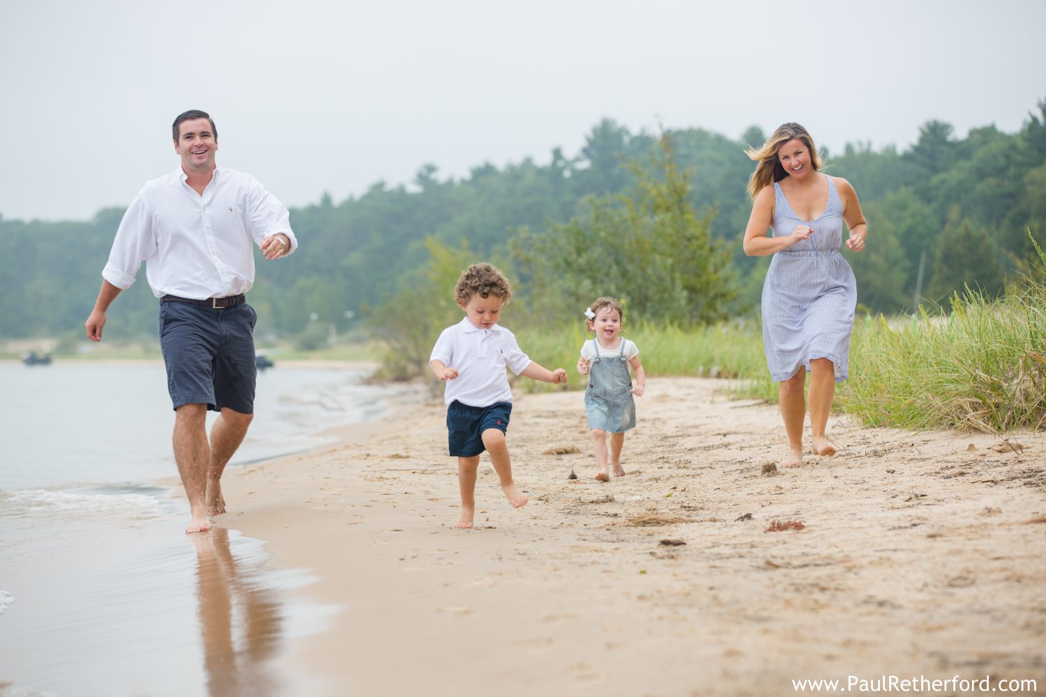 family running on beach photo