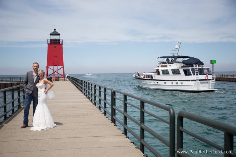 first look charlevoix michigan lighthouse pier wedding photo