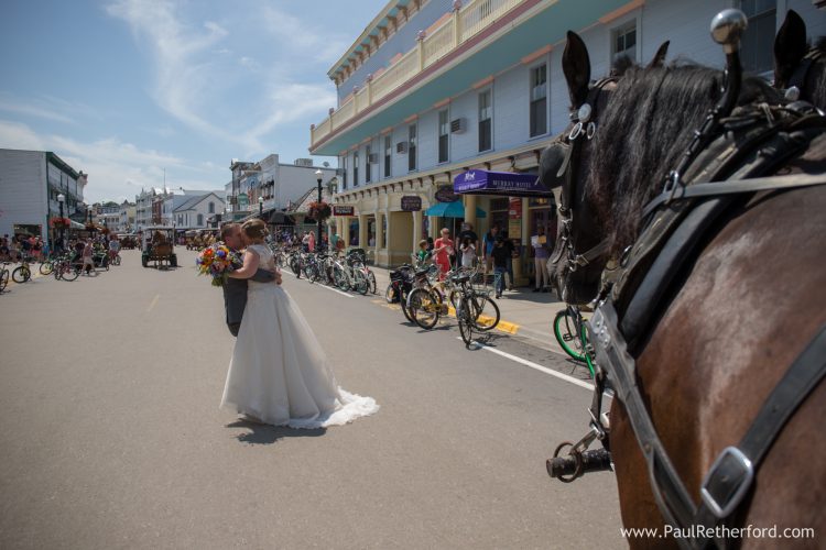 bride groom kissing downtown mackinac island photo