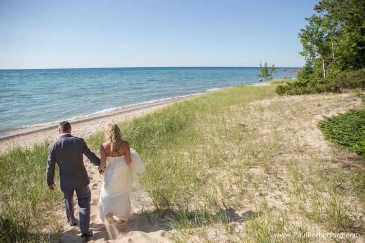 walking on beach wedding photo northern michigan