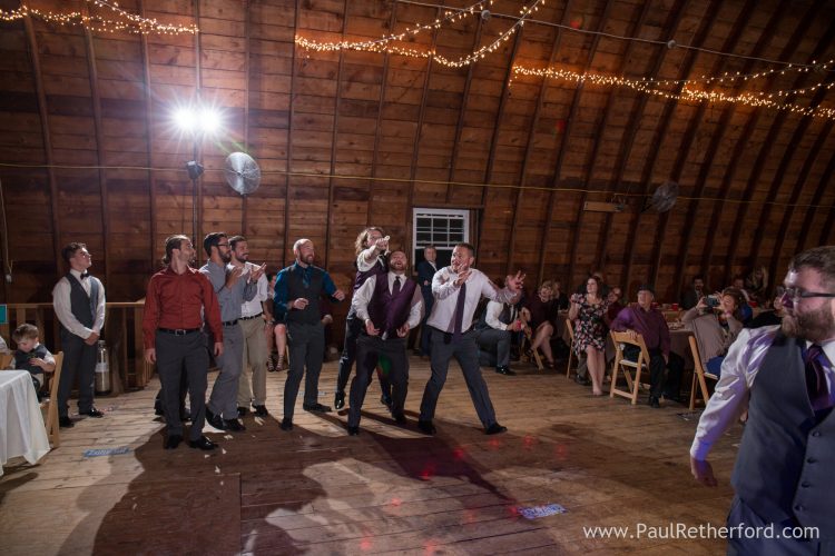 garter toss farm wedding photo